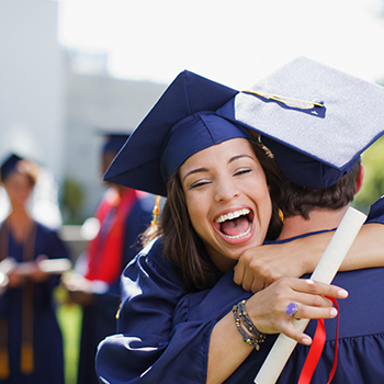 graduates hugging 