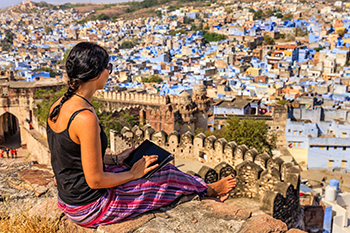 young woman looking out over mountain town